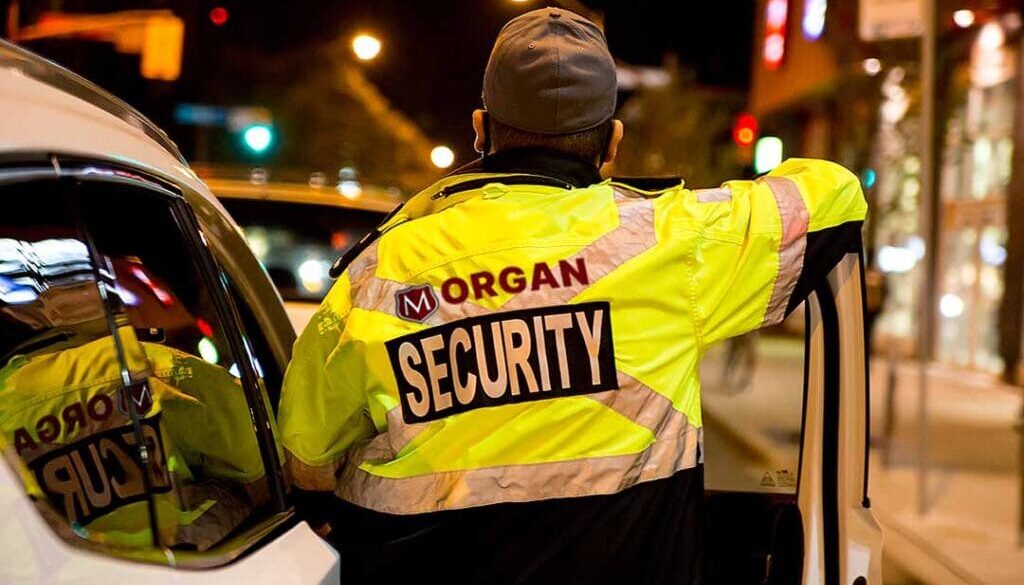 Mobile Patrols - Morgan Security Mobile Patrol Guard beside a Security vehicle.
