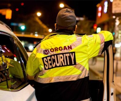Mobile Patrols - Morgan Security Mobile Patrol Guard beside a Security vehicle.