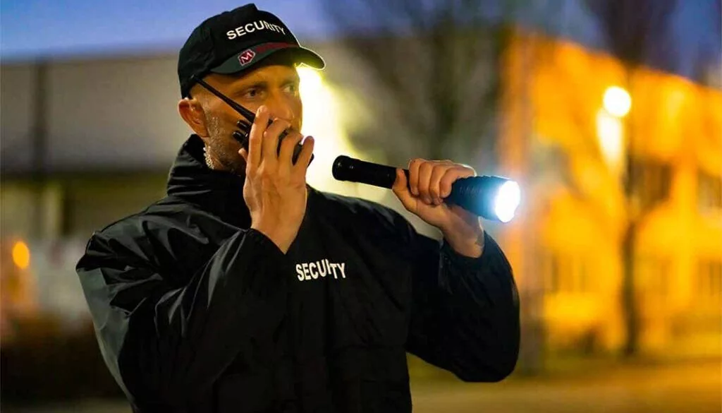 Morgan Security guard performing foot perimeter patrols. Security Guards are backed up with CCTV Monitoring, Mobile Patrols, and Guard Tracking services in Illinois, Indiana, and Chicago.